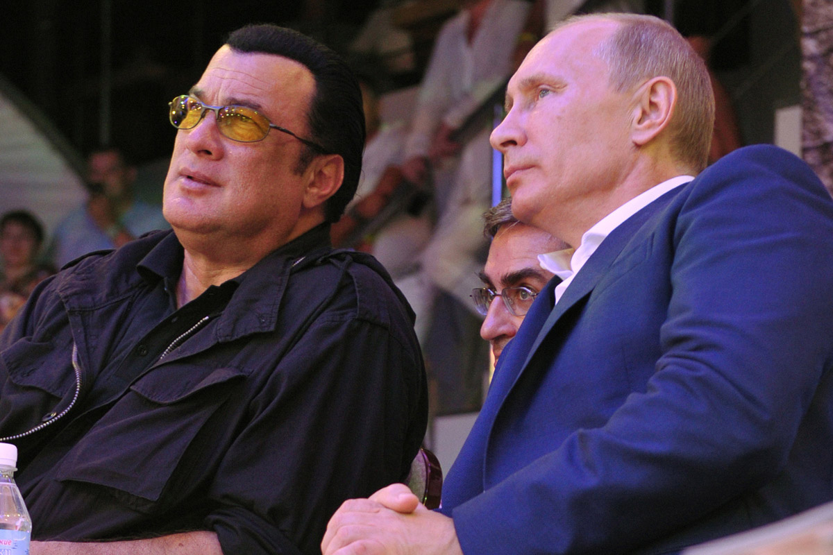 Russian President Putin and U.S. actor Seagal watch the first Russian national championship of mixed martial arts in Sochi
