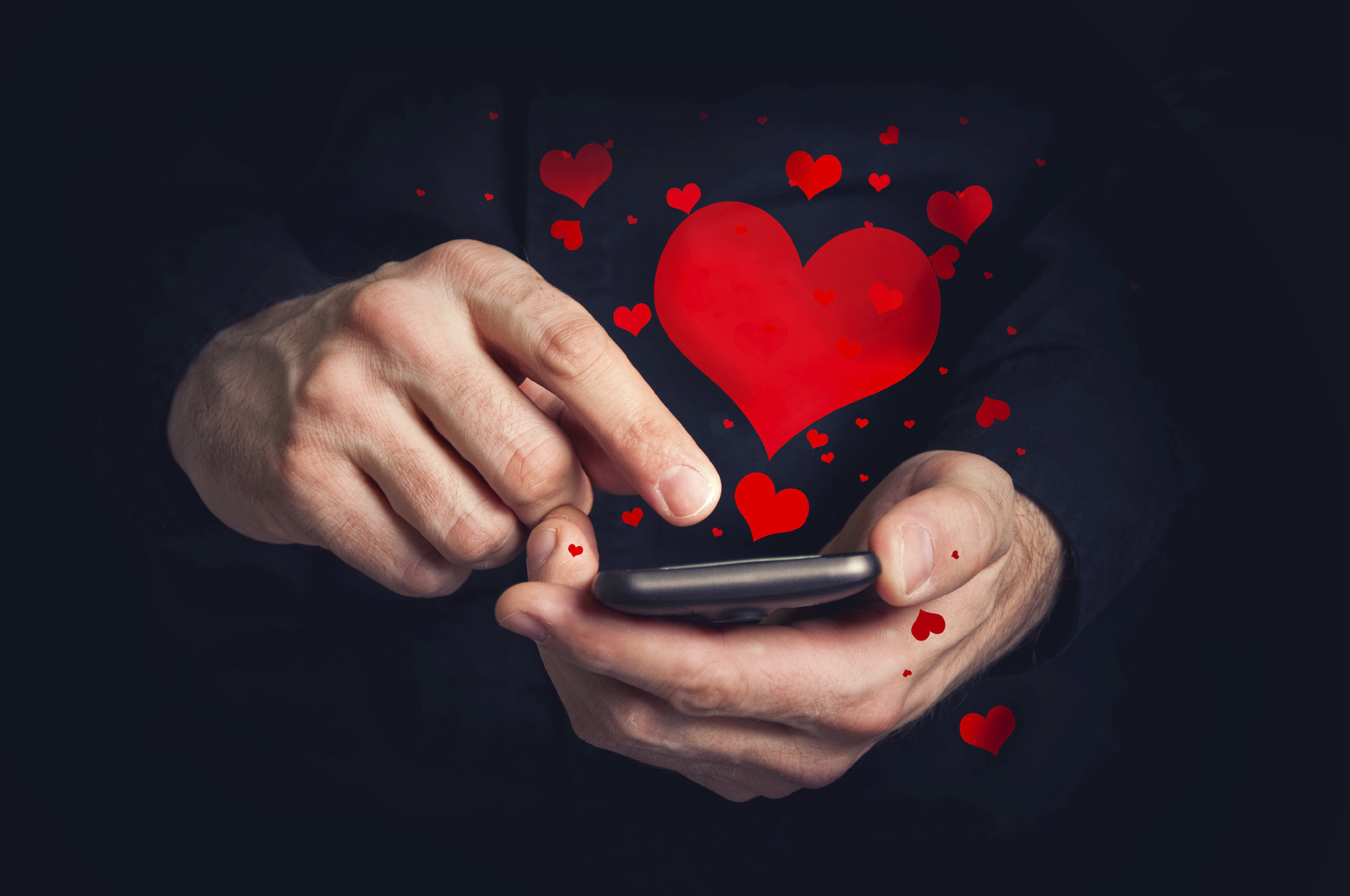 Man typing love text messages on a smartphone for Valentine's da