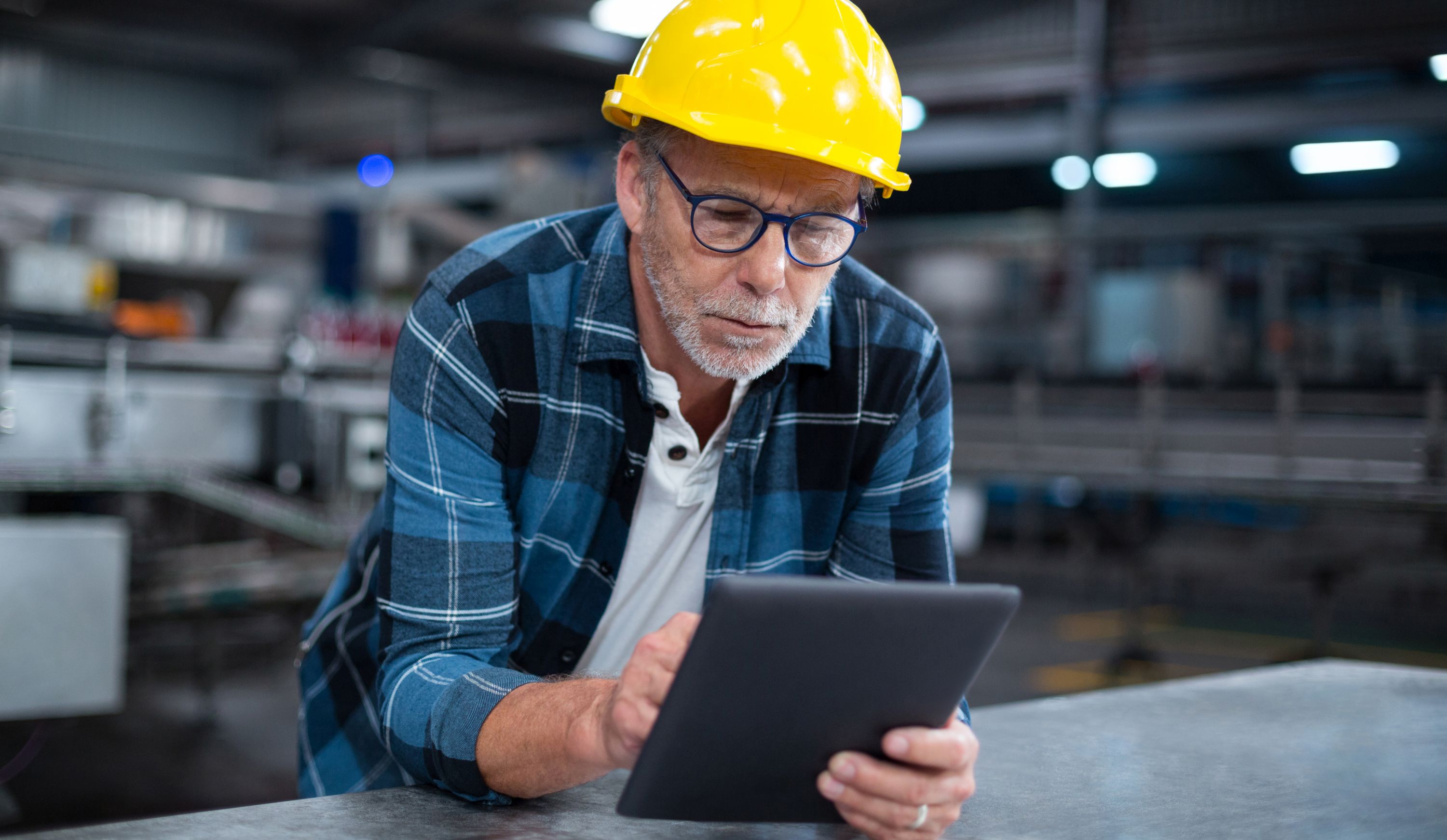 Factory worker using a digital tablet in factory